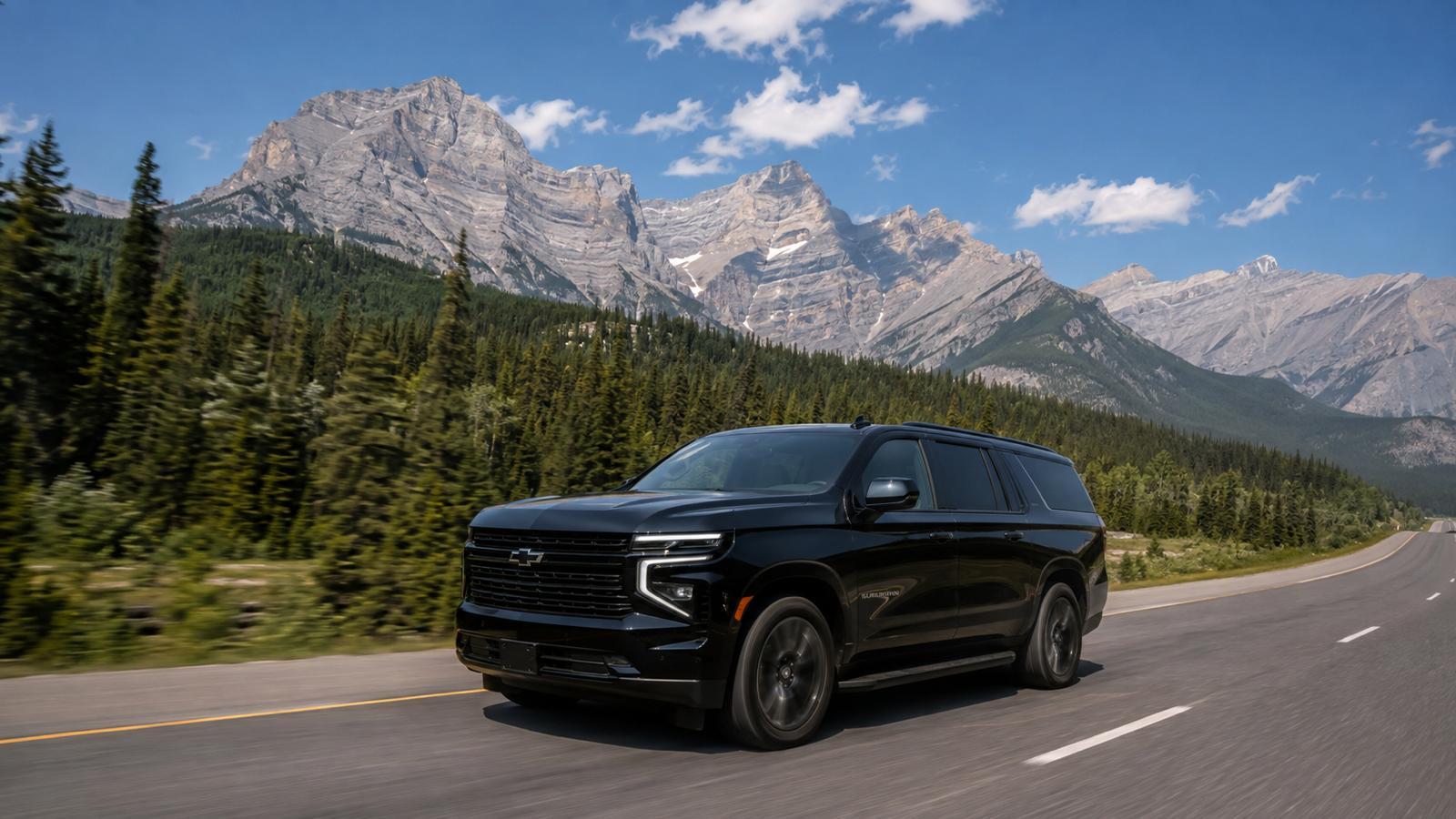 A PrimeKar SUV on the highway toward the Rocky Mountains